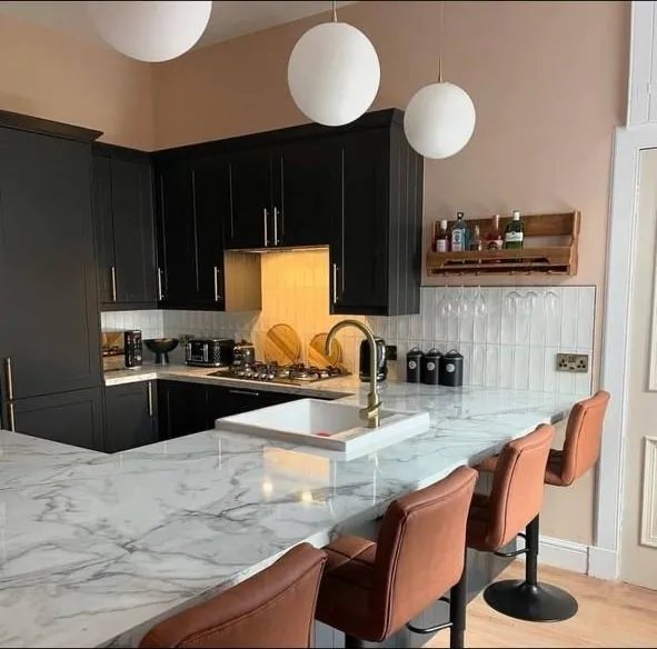 Black shaker kitchen with marble-effect island and breakfast bar