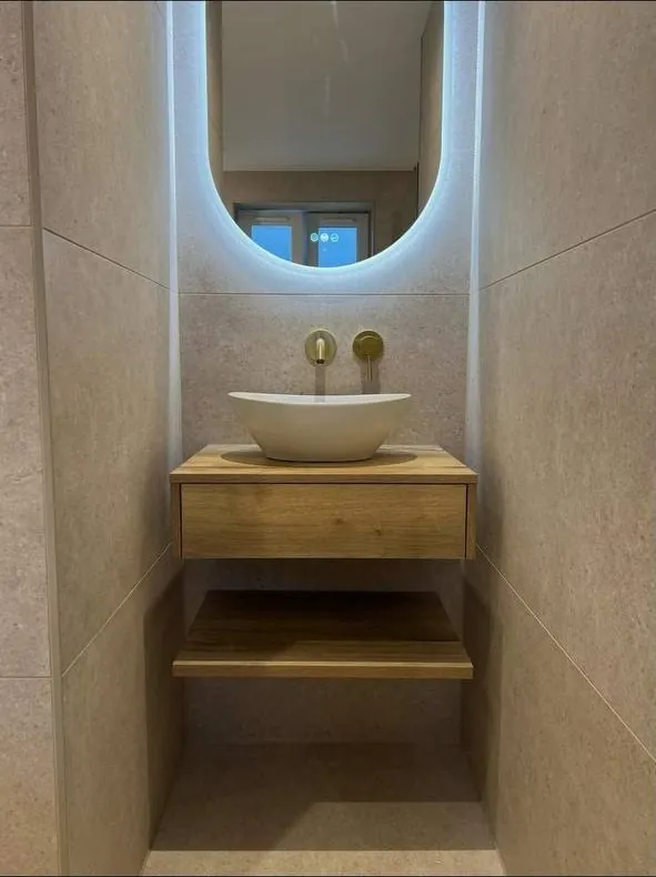 Cloakroom with oak vanity unit and brass taps