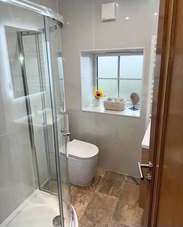 Shower room with quadrant enclosure and wood-effect floor