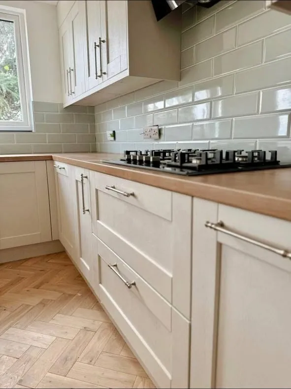 White shaker kitchen with oak worktop and island